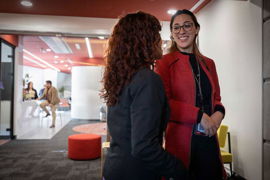 A pair of women pause at an RGA office to chat